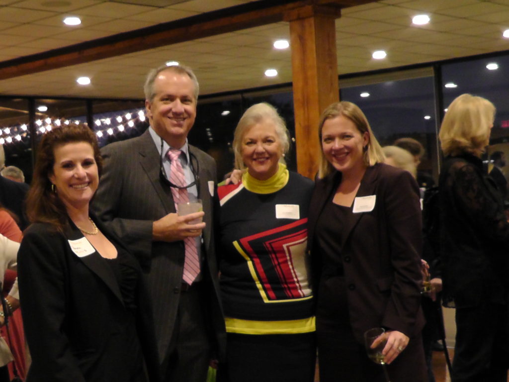 Theile McVey of Kassel McVey (right) poses with attendees at the Appleseed award reception for Inez Moore Tenenbaum.